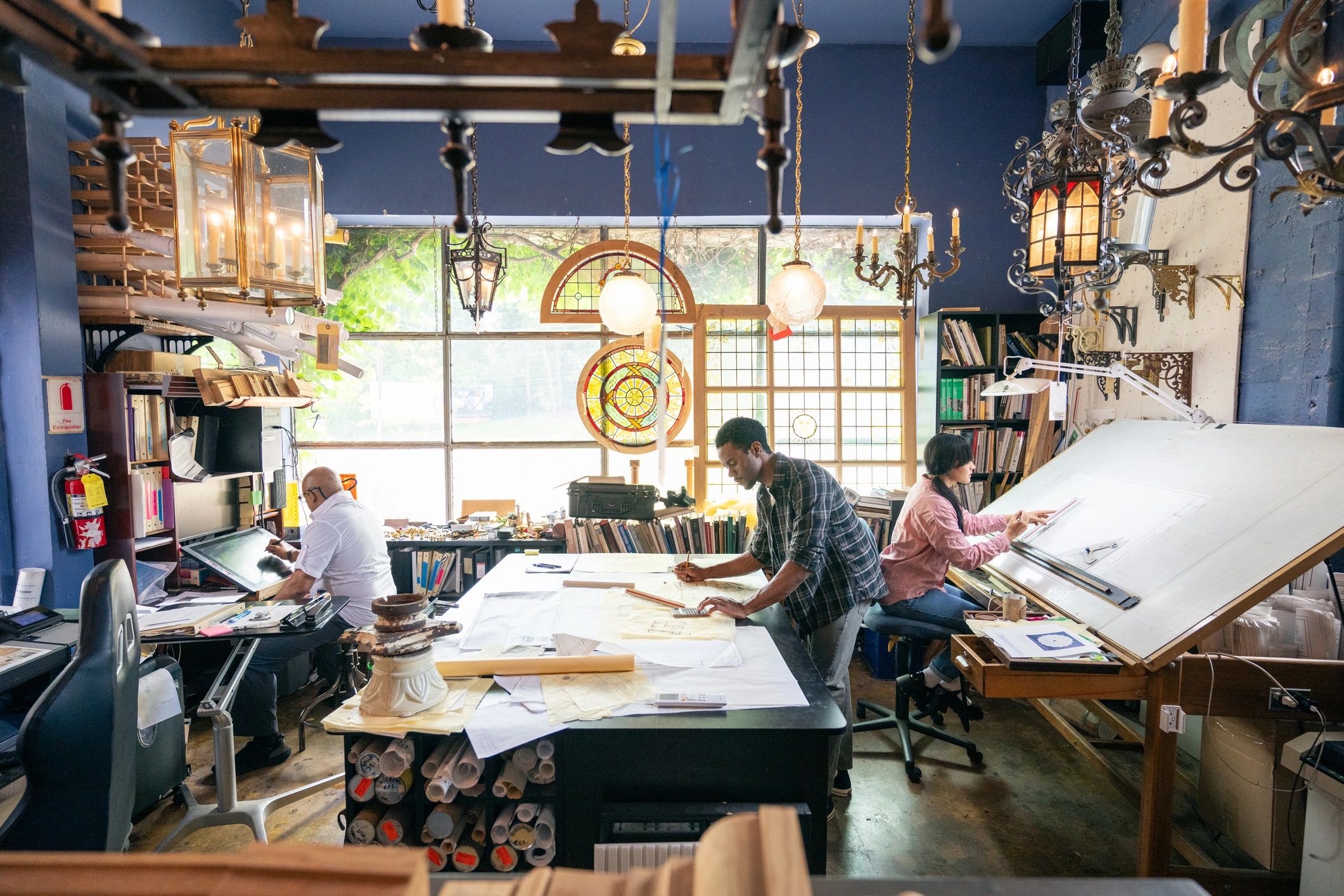 Wide shot of a Team of architects working in the studio on a home renovation project